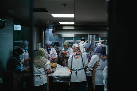 a group of people in a kitchen preparing food