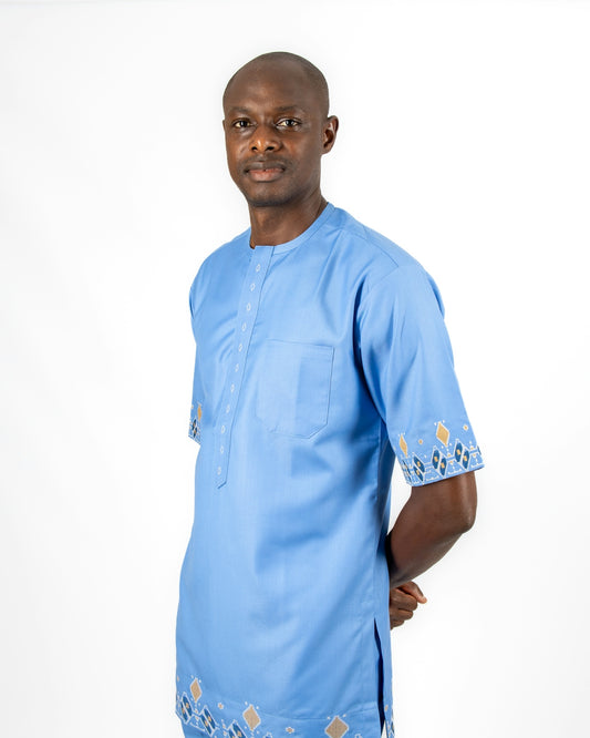 A man in a blue shirt is posing for a picture